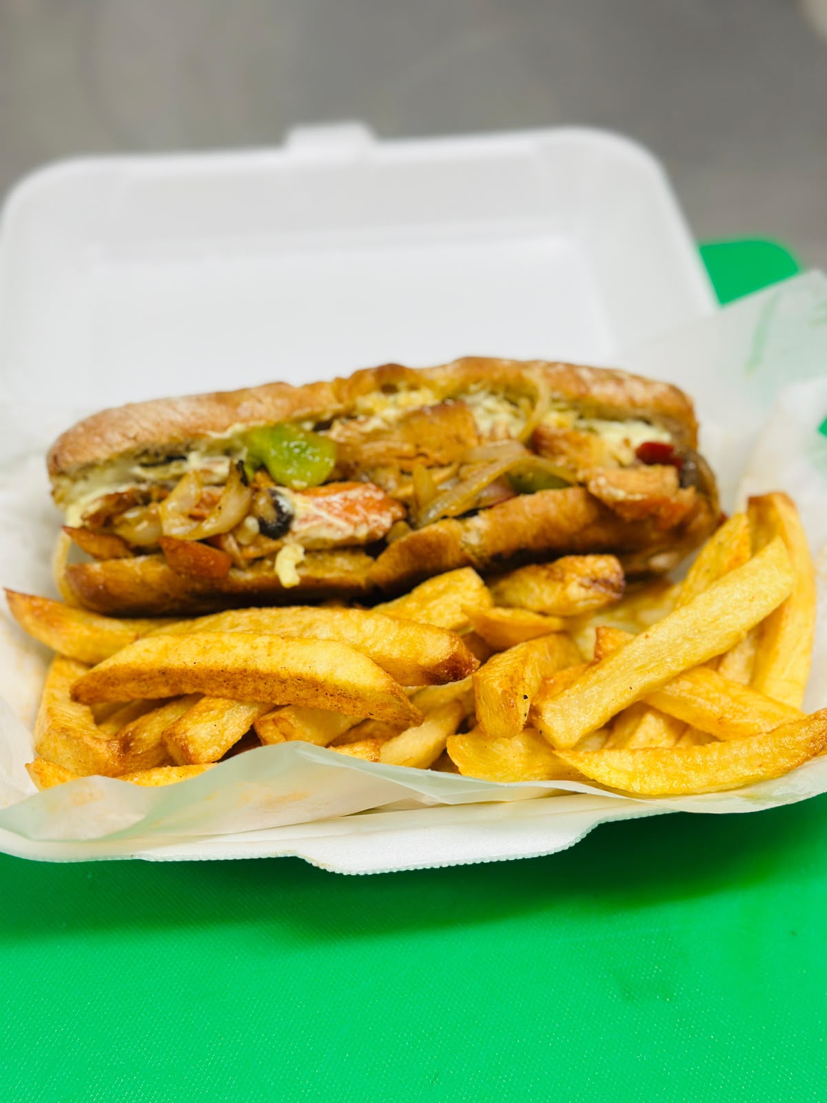 Chicken sub with peppers and onions, served with chips — Gonubie